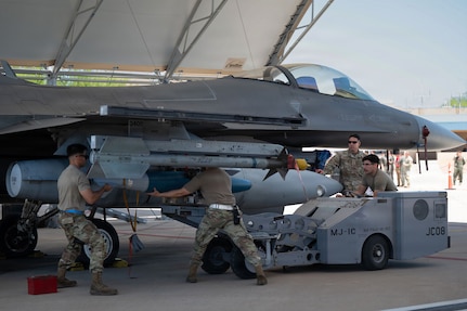 U.S. Air National Guard service members assigned to the 152nd Fighter Squadron Aircraft Maintenance Unit load munitions to an F-16 Fighter Falcon during the annual Weapons Load Competition at Morris Air National Guard Base, Arizona, May 1, 2026.