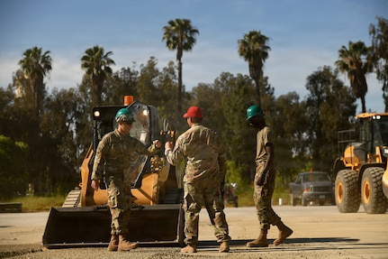 U.S. Air Force Senior Master Sgt. Reuben Dominguez, 163rd Regional Training Site superintendent, California Air National Guard, gives kudos to Airmen after operating a skid-steer successfully during a weeklong Rapid Damage Repair course at March Air Reserve Base, California, May 19, 2026.