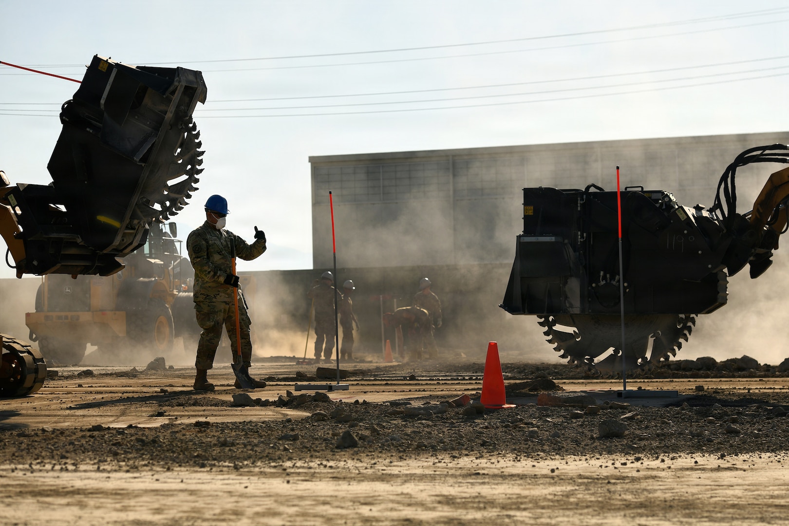 U.S. Air Force Staff Sgt. Tarama Fuatagavi, 154th Civil Engineer Squadron, Hawaii Air National Guard, gives hand and arm signals to direct a skid steer outfitted with a concrete saw during a weeklong Rapid Damage Repair course, March Air Reserve Base, California, May 20, 2026.