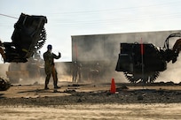 U.S. Air Force Staff Sgt. Tarama Fuatagavi, 154th Civil Engineer Squadron, Hawaii Air National Guard, gives hand and arm signals to direct a skid steer outfitted with a concrete saw during a weeklong Rapid Damage Repair course, March Air Reserve Base, California, May 20, 2026.