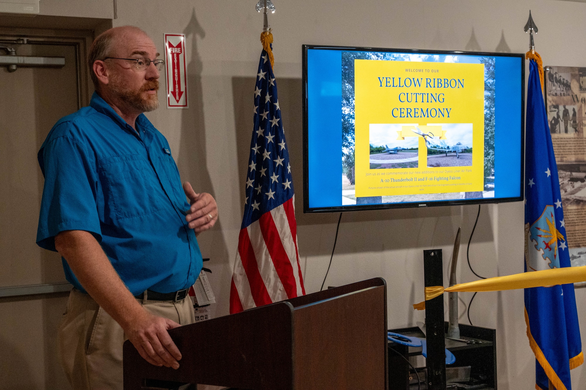 Walter Nicolds, Dyess Memorial Museum and Linear Air Park curator, delivers opening remarks during a yellow ribbon cutting ceremony inside the Dyess Memorial Museum at Dyess Air Force Base, Texas, May 21, 2026. The ceremony, which was moved inside the Dyess Memorial Museum due to inclement weather, celebrated the addition of the A-10 Thunderbolt II and F-16 Fighting Falcon to the Linear Air Park. (U.S. Air Force photo by Airman 1st Class William Neal)