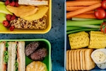 Overhead picture of three lunchboxes full of healthy food