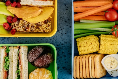Overhead picture of three lunchboxes full of healthy food