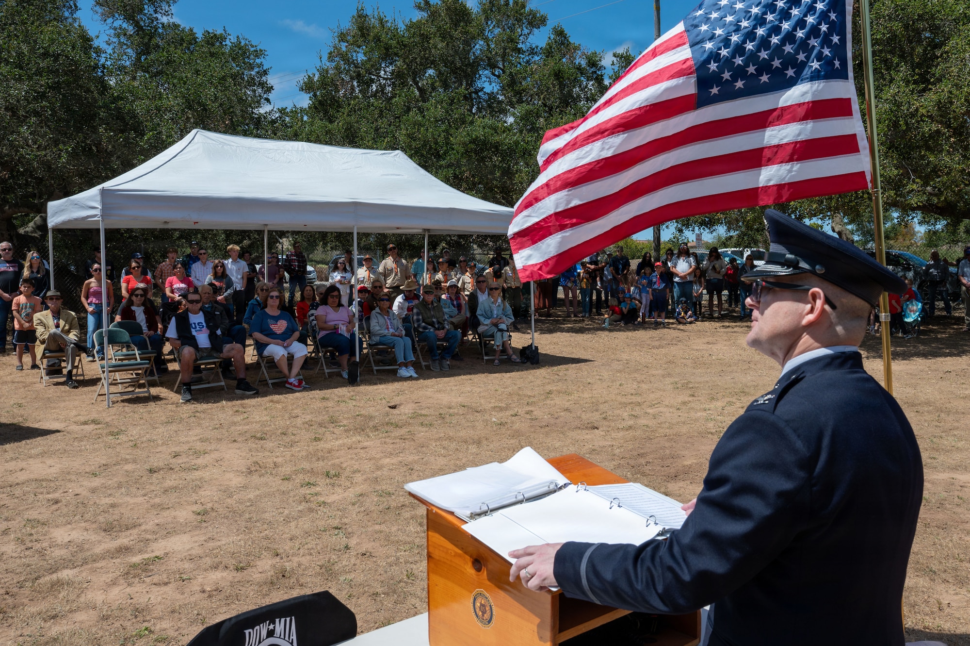 a man stands at a podium and delivers a speech to a crowd