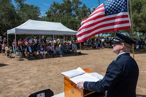 a man stands at a podium and delivers a speech to a crowd