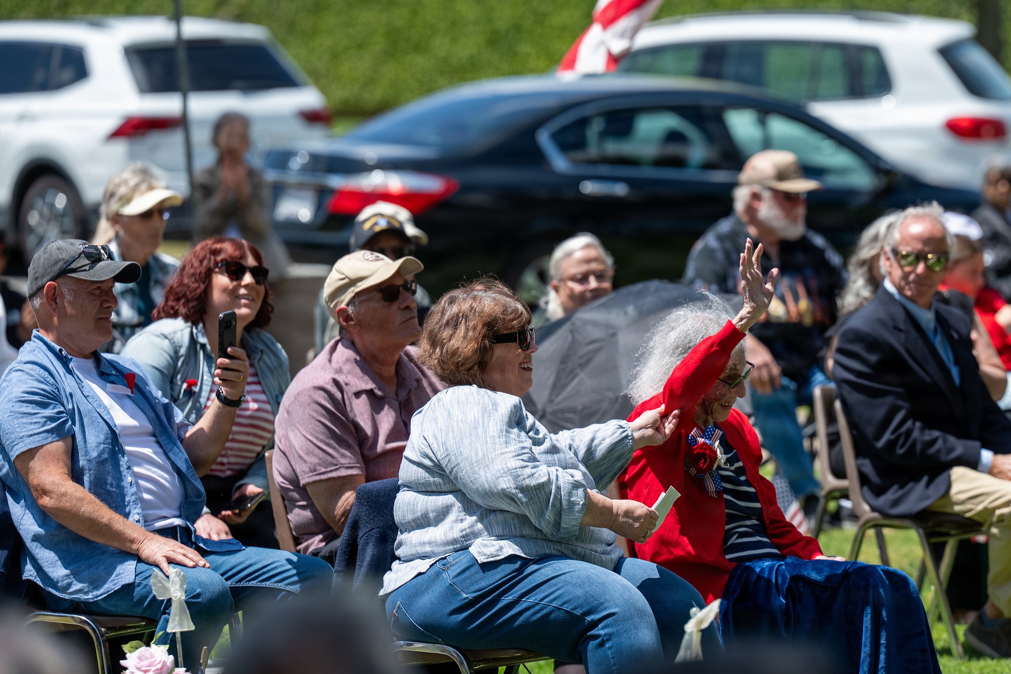 Lucille ‘Sue’ Friend Manson, 102 year old veteran, raises her arm with aid from family.