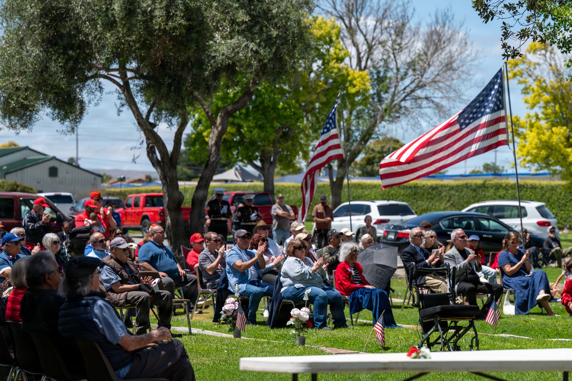 Veterans, family and friend clap while seated at the Memorial Day ceremony.