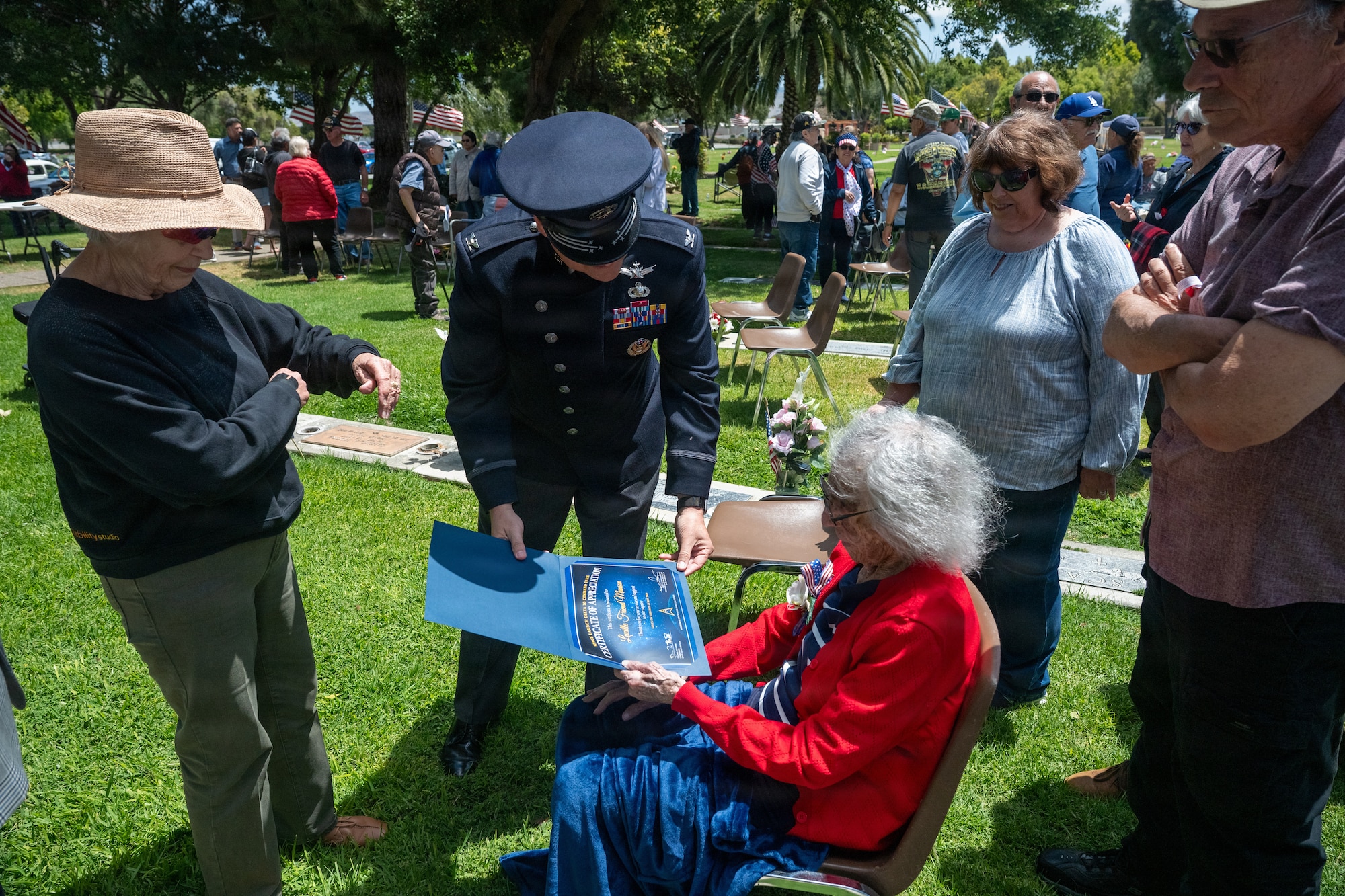 Col. Horne hands 102 year old veteran a certificate of appreciation.