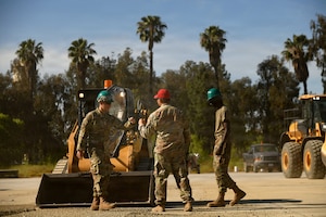 U.S. Air Force Senior Master Sgt. Reuben Dominguez, 163rd Regional Training Site superintendent, California Air National Guard, gives kudos to Airmen after operating a skid-steer successfully during a weeklong Rapid Damage Repair course at March Air Reserve Base, California, May 19, 2026.