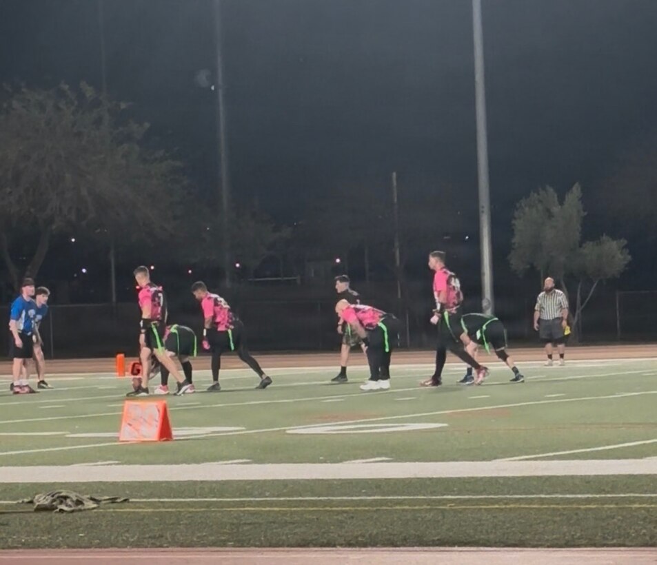 Marine Corps Logistics and Operations Group's flag football team, the Rusty Buffaloes, plays during the 2026 Commander's Cup Flag Football Championship, at Marine Corps Air Ground Combat Center, California, March 30, 2026.  The flag football team was originally formed in 2023 by the late Gunnery Sgt. Robert McDonald. Though only six players from the original team formed by McDonald remain, the mission has never changed: every game is played in his honor and his impact is still felt across the team long after his passing.