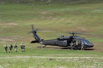 Army parachute riggers assigned to Defense Logistics Agency Distribution, Susquehanna, Pennsylvania, join airmen from the 148th Air Support Operations Squadron, a subordinate unit of the 193rd Special Operations Wing based at Fort Indiantown Gap, for a static line jump at Fort Indiantown Gap, April 30, 2026. (DOW photo by Dorie Heyer, released)