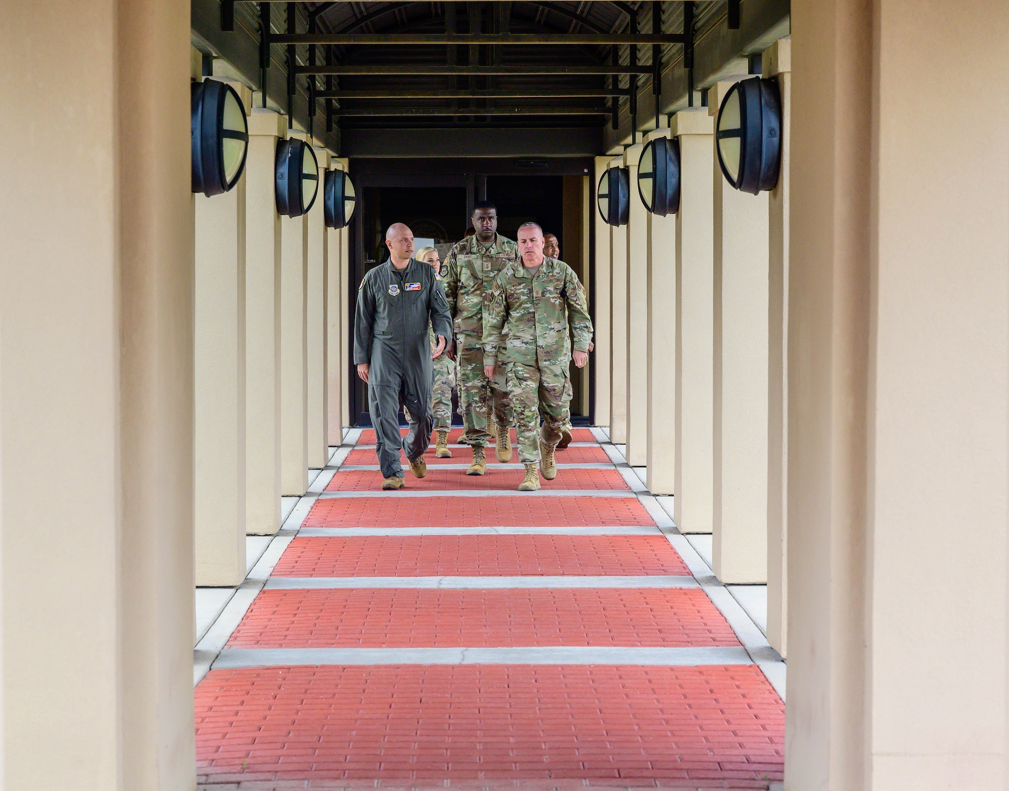 CMSAF and accompanying Airmen walk up pathway