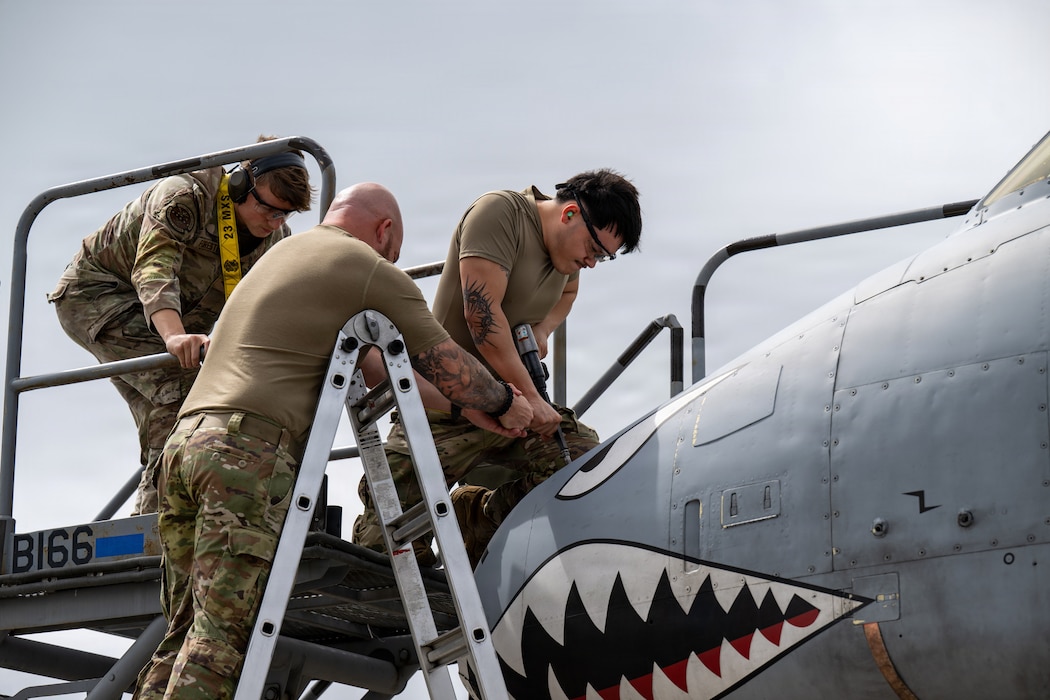 Maintainers working on an A-10C Thunderbolt II.