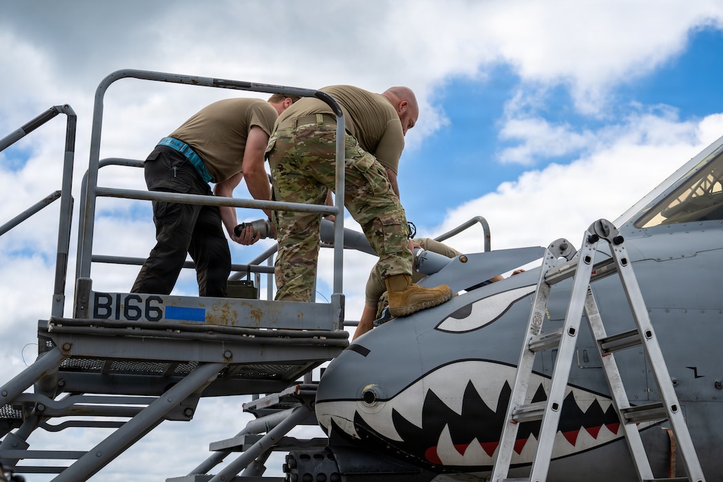 Military members working on an A-10C Thunderbolt II.