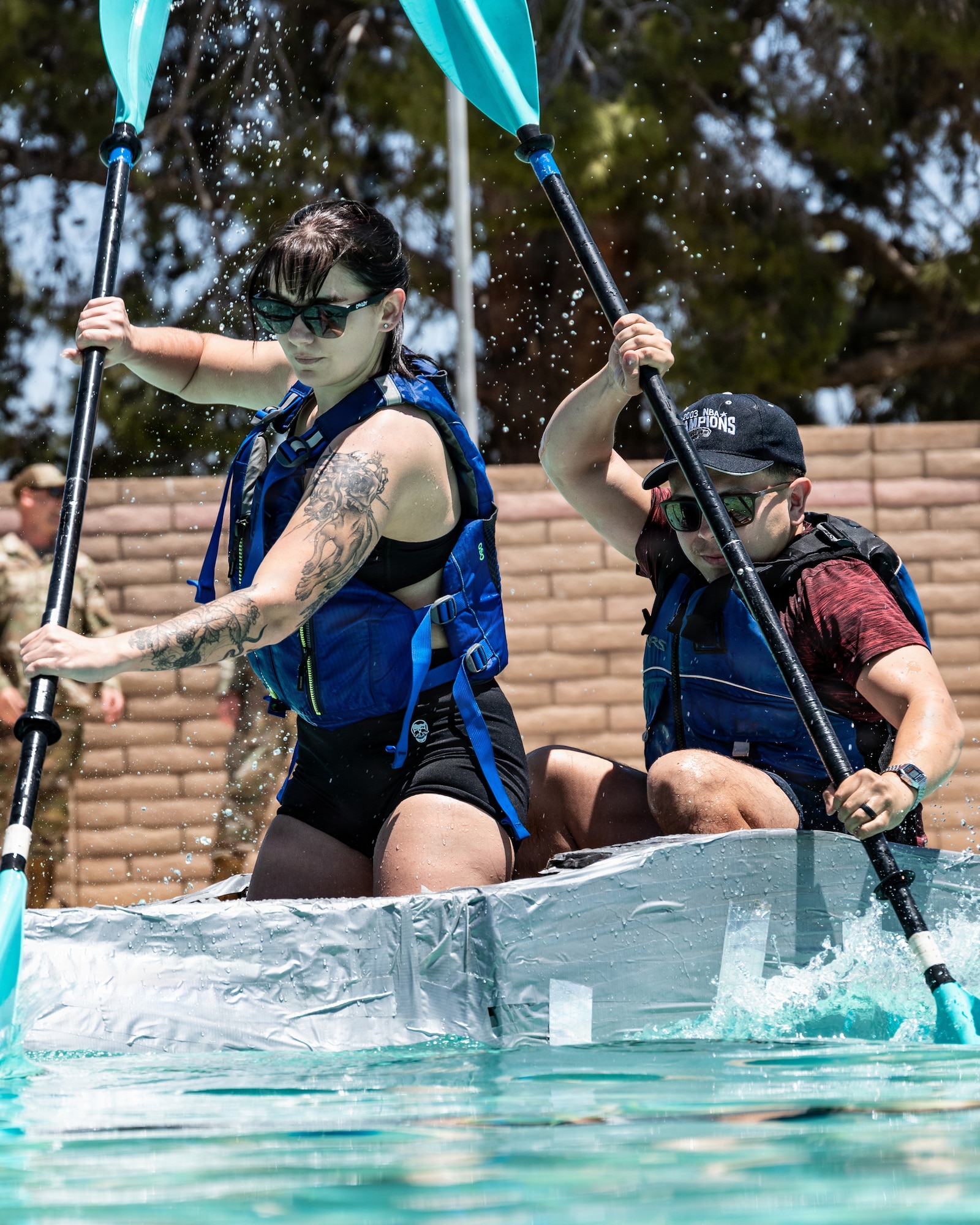 U.S. Air Force Senior Airmen Angelina Bibbee, left, and Nick Castillo, 56th Civil Engineer Squadron power production technicians, compete in the annual 56th CES Boat Regatta at Luke Air Force Base, Arizona, May 20, 2026.