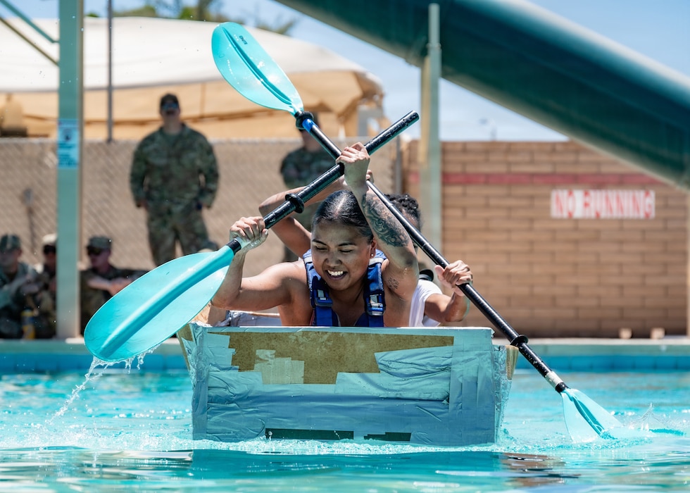 U.S. Air Force Senior Airman Mary Ramos, 56th Civil Engineer Squadron operations management journeyman, propels her cardboard craft toward the end of the course during the annual 56th CES Boat Regatta at Luke Air Force Base, Arizona, May 20, 2026.