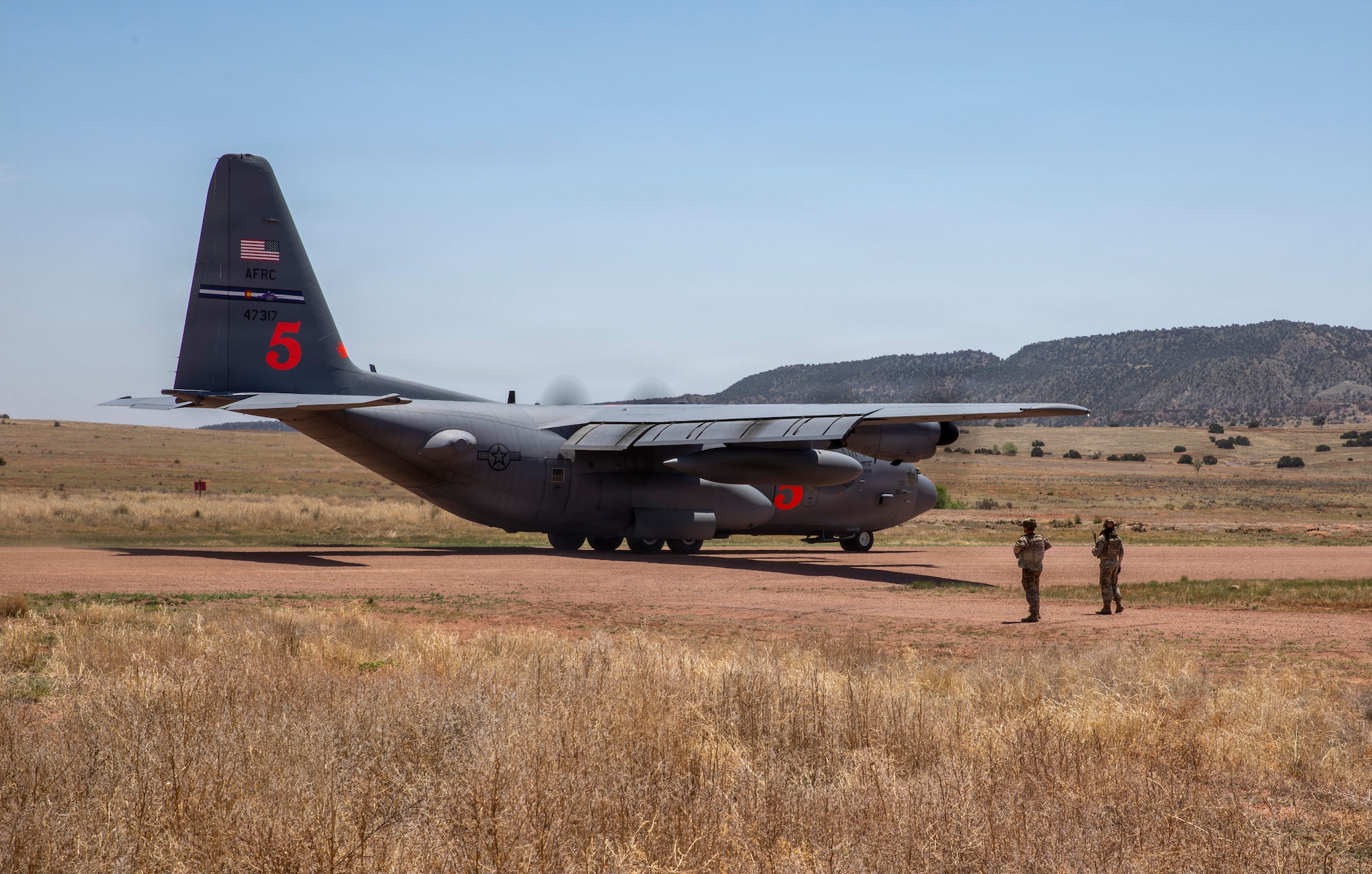 C-130 on a dirt landing strip