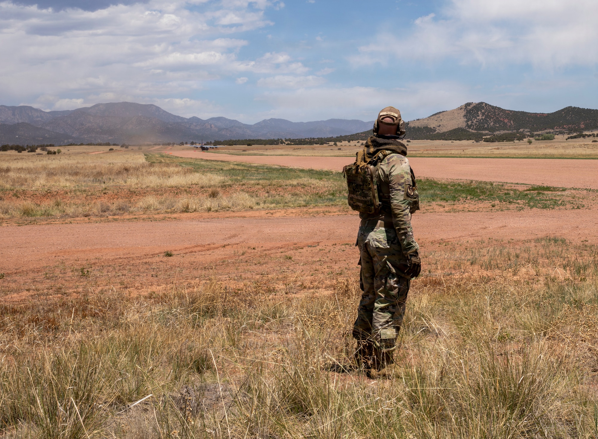 Airman watches a C-130 landing