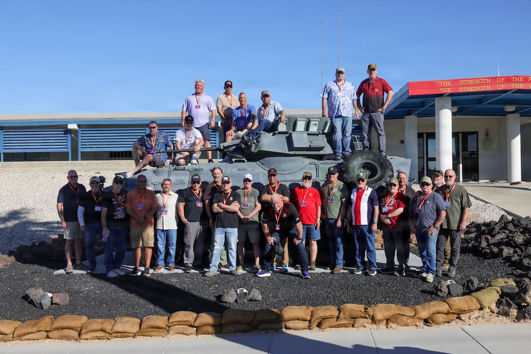 U.S. Marine Corps veterans with 3d Light Armored Reconnaissance Battalion, 1st Marine Division, pose for a photo in front of the 3d LAR command post during an alumni appreciation day on Marine Corps Air Ground Combat Center, Twentynine Palms, California, April 10, 2026. 3d LAR hosted an alumni event for veterans and their families to showcase appreciation and tradition within the Marine Corps. (U.S. Marine Corps Photo by Lance Cpl. Jozef P. Majewski)