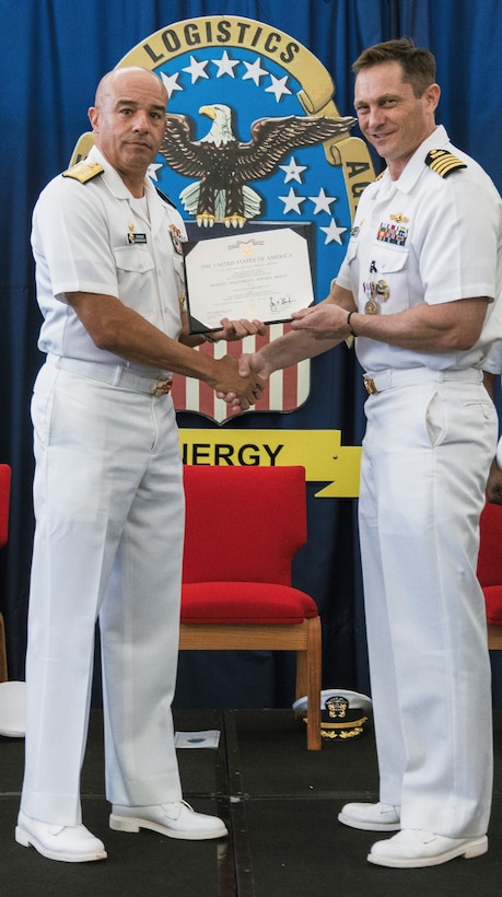 Two men holding an award.