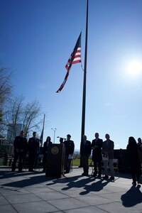 A U.S. flag flies over a speaking stand.