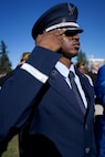 An Air Force Airman in dress blues salutes.