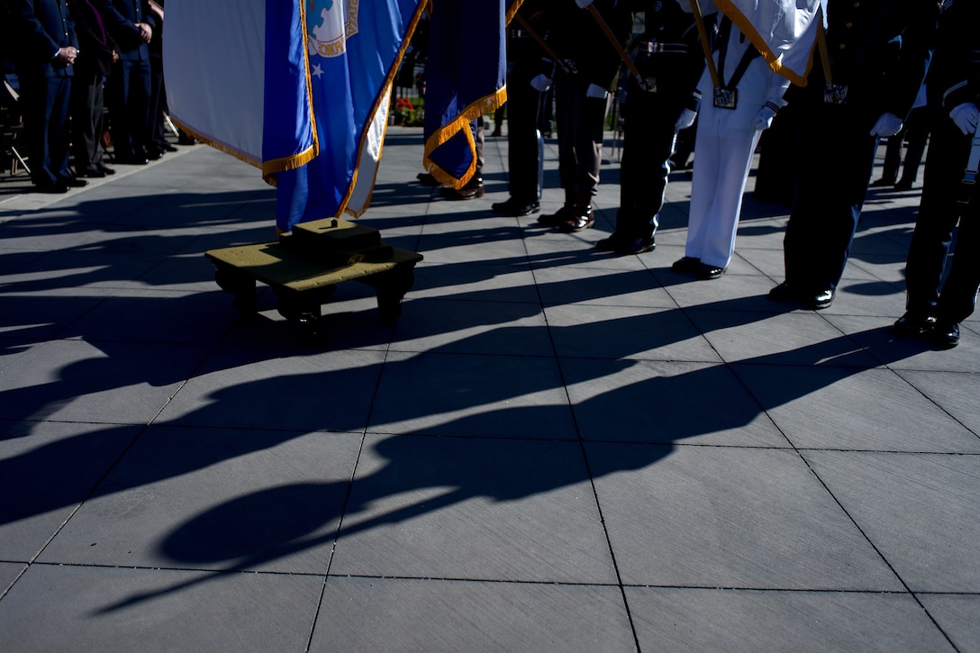 Shadows and the feet of a military honor guard.