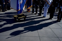 Shadows and the feet of a military honor guard.