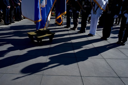 Shadows and the feet of a military honor guard.
