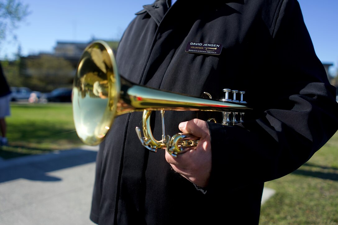 A closeup of a bugle held by the bugler.