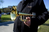 A closeup of a bugle held by the bugler.