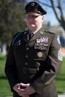 A decorated Army command sergeant major in dress green uniform.