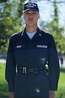 Cadet in blue uniform standing at attention.