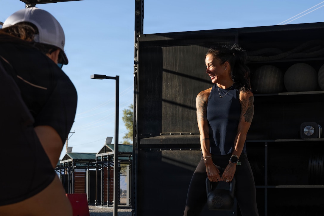 U.S. Marine Corps retired Master Sgt. Andrea M. Ruiz, wife of the 20th Sergeant Major of the Marine Corps Sgt. Maj. Carlos A. Ruiz, performs kettlebell squats during Spouse Physical Training at the Del Valle Outdoor Fitness Center, Marine Corps Air Ground Combat Center, Twentynine Palms, California, May 8, 2026. Hosted in honor of Military Spouse Appreciation Day, this event provides a venue to foster community resilience and recognize the vital role families play in supporting the readiness and stability of the force. (U.S. Marine Corps photo by Lance Cpl. Cleo Wang)