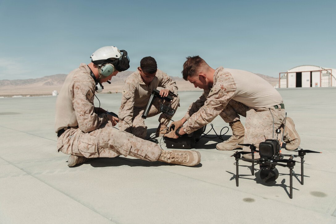 U.S. Marines, all small unmanned aircraft system operators with 3rd Light Armored Reconnaissance Battalion, 1st Marine Division, fix a first-person view sUAS during a drone aviation integration test near Quackenbush training area, Marine Corps Air Ground Combat Center, Twentynine Palms, California, May 13, 2026. This sUAS integration training teaches Marines to adapt to enemy unmanned aircraft by emphasizing battlefield awareness, disciplined maneuvers, and a shared understanding of how these systems will shape future ground operations. (U.S. Marine Corps photo by Lance Cpl. Gracelyn Hanson)