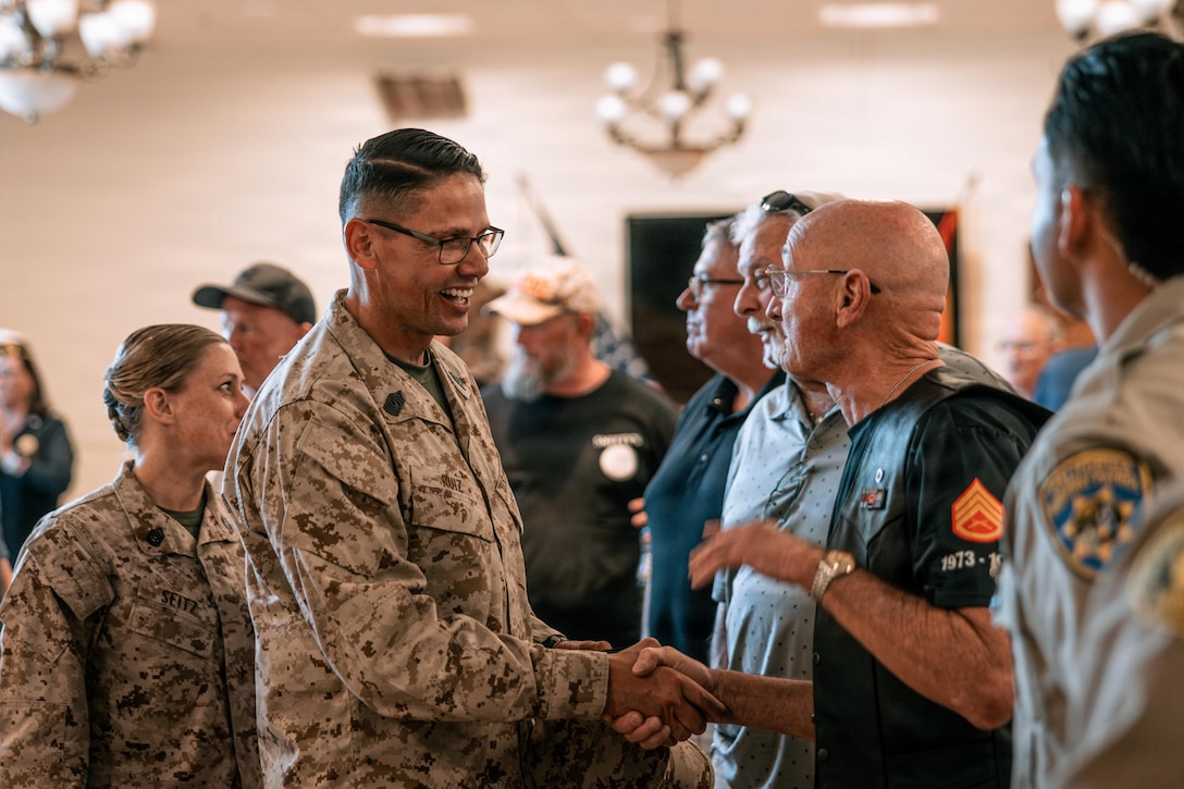 U.S. Marine Corps Sgt. Maj. Carlos A. Ruiz, the 20th Sergeant Major of the Marine Corps, shakes a veteran’s hand inside the Mesa conference room at Marine Corps Air Ground Combat Center, Twentynine Palms, California, May 8, 2026. By engaging directly with those living and working on or around base, Ruiz can gain firsthand insight into the quality of life and the challenges presented by serving at a remote and isolated installation. (U.S. Marine Corps photo by Lance Cpl. Parker Peichel)