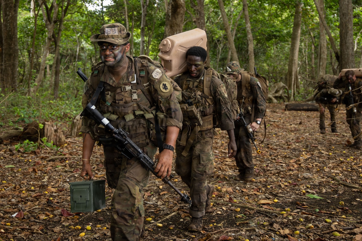 U.S. service members and Panamanian partners move through the jungle while carrying equipment and supplies during the Green Mile event as part of the Jungle Operations Training Course–Panama at Aeronaval Base Cristóbal Colón, Panama, May 14, 2026. The training strengthened interoperability and reinforced the enduring partnership between U.S. forces and Panamanian security institutions through combined jungle operations in a demanding tropical environment. (U.S. Army photo by Sgt. Nirak Garcia Navarro)