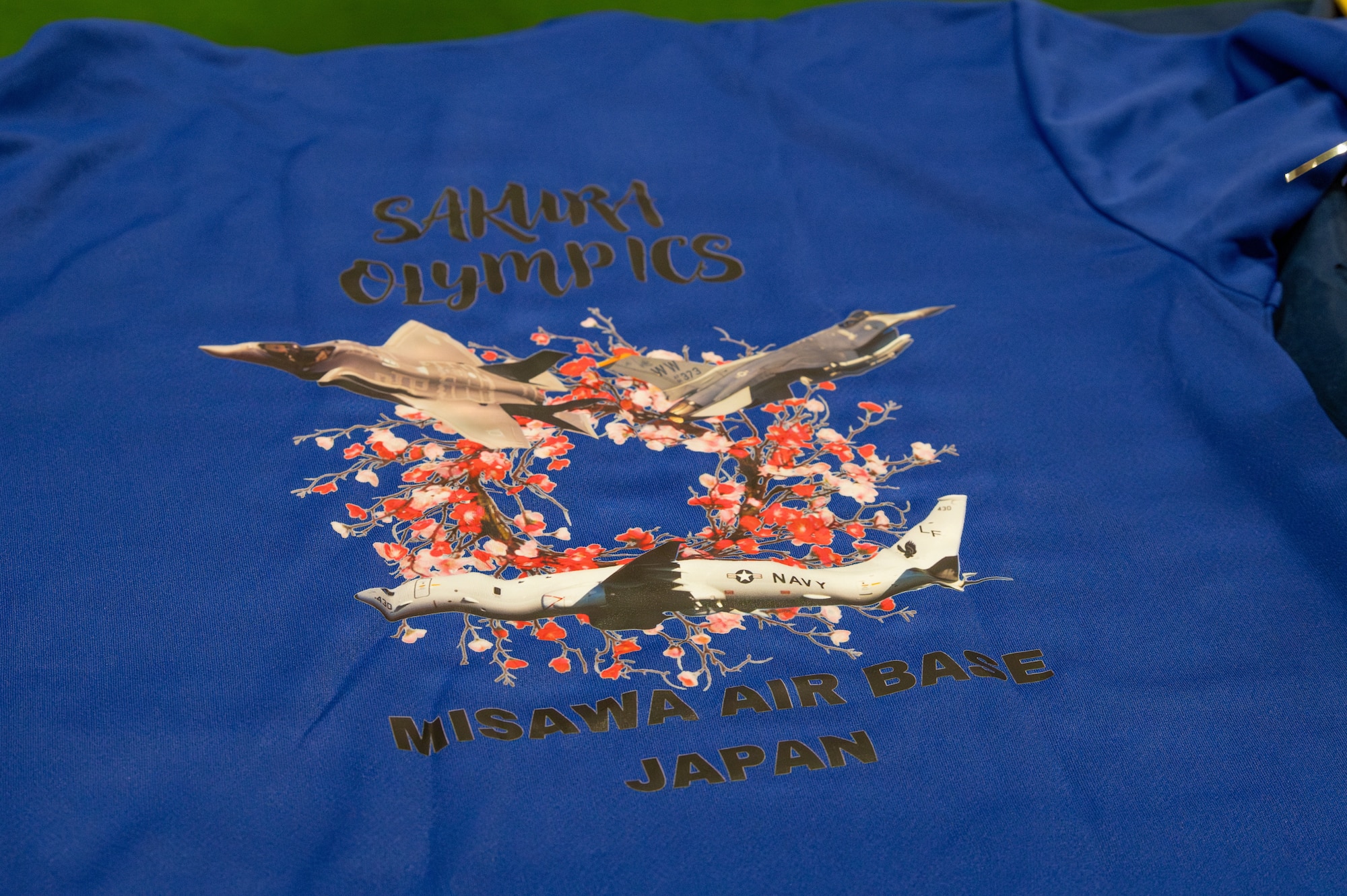 A morale shirt is displayed during the 2026 Sakura Olympics opening ceremony at Misawa Air Base, Japan, May 11, 2026.