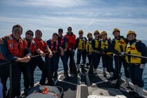 Members of the U.S., Canadian and Japan Coast Guards pose for a group photo during a joint search and rescue exercise in the Strait of Juan de Fuca, May 21, 2026.