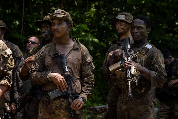 U.S. service members and Panamanian partners stand in formation while receiving instructions before the Green Mile event as part of the Jungle Operations Training Course–Panama at Aeronaval Base Cristóbal Colón, Panama, May 14, 2026. The training strengthens interoperability and reinforces the enduring partnership between U.S. forces and Panamanian security institutions through combined jungle operations and shared tactical experience. (U.S. Army photo by Sgt. Nirak Garcia Navarro)