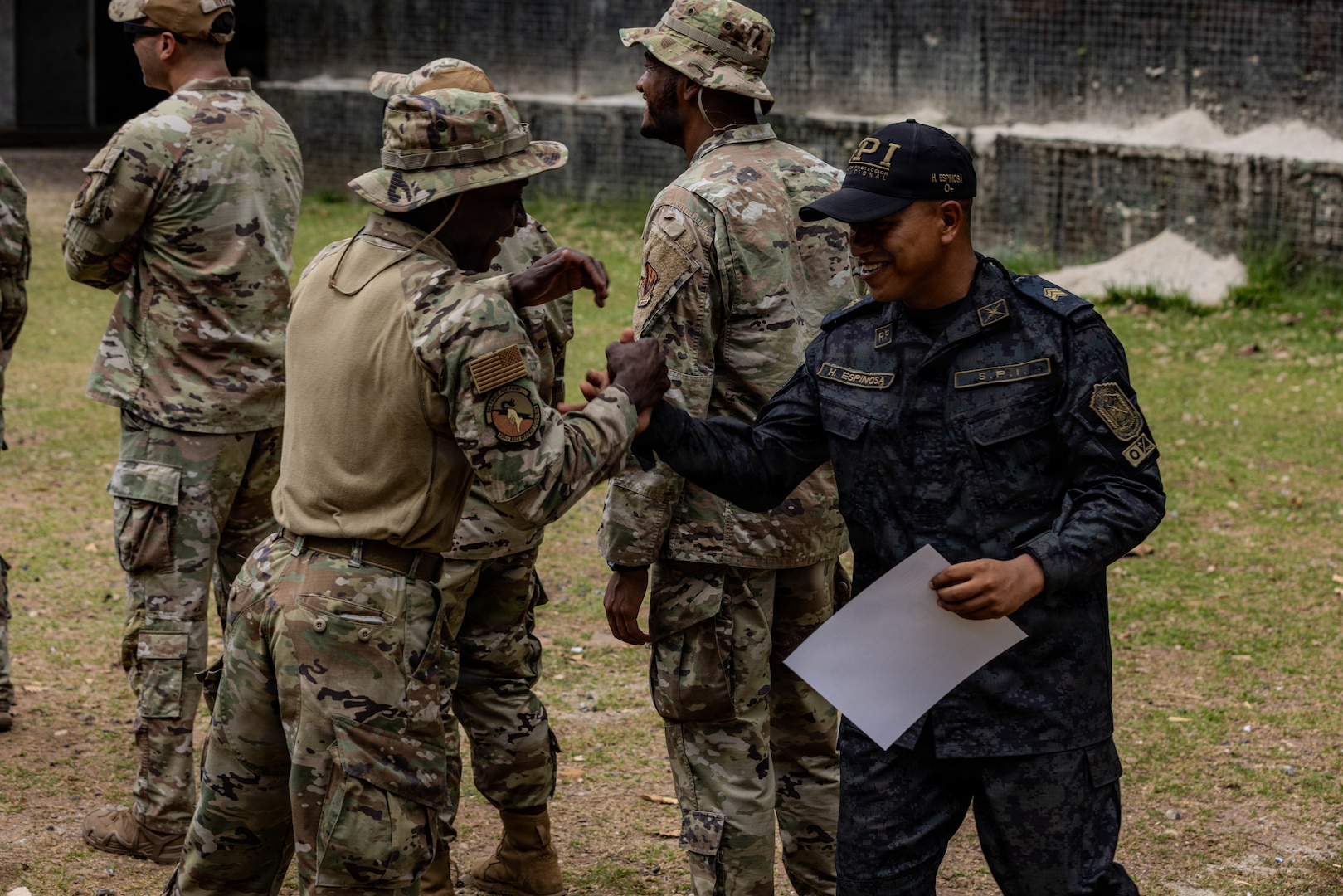 U.S. Airmen assigned to the 824th Base Defense Squadron, shake hands with a member of the Servicio de Protección Institucional during a graduation ceremony at Cerro Tigre, Panamá, April 17, 2026. U.S. Southern Command seeks to expand its ongoing coordination, collaboration, and security efforts where U.S. military personnel and Panamanian security institutions can bolster collective capabilities and skills, as well as facilitate a joint learning environment. (U.S. Army photo by Spc. Richard Morgan)
