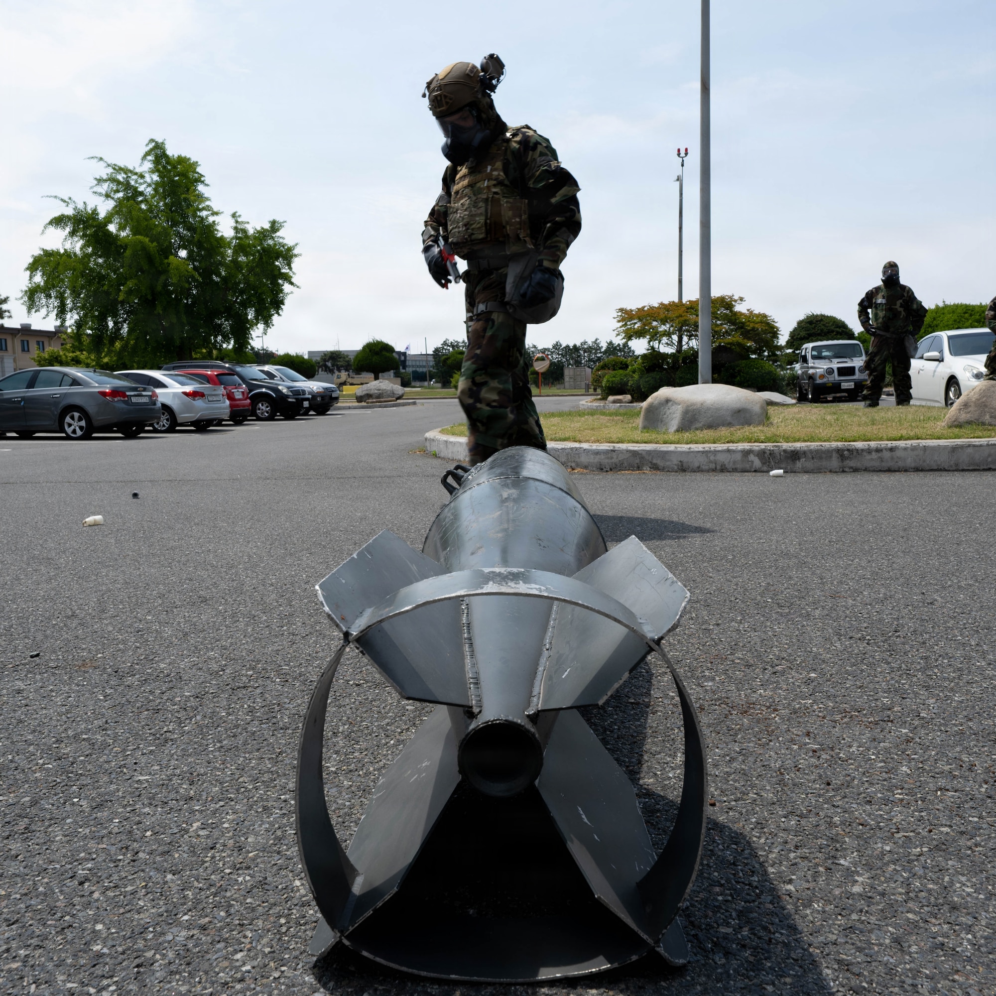 Airman examines a simulated unexploded ordinance.