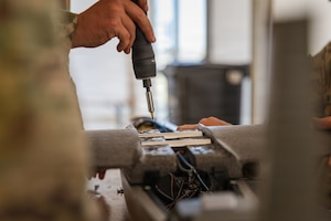 U.S. Army Staff Sgt. Terrence A. Giles, with the Field Artillery Squadron, 2d Cavalry Regiment, secures the wings of a one-way attack Hornet drone in preparation for flight operations at Bemowo Piskie Training Area, Poland, May 3, 2026. From April 27 to May 31, 2026, U.S. and Allied forces will exercise NATO’s Eastern Flank Deterrence Initiative, demonstrating NATO’s ability to fight and win on the modern battlefield. Nearly 15,000 troops from eleven nations will train across the High North, Baltic region, and Poland, executing rapid maneuvers, air defense, counter-drone operations, and cyber defense to validate NATO’s regional defense plans in real time. This series of linked exercises, including Saber Strike, Immediate Response, and Swift Response, turns investment into capability. Soldiers integrate unmanned systems, AI-enabled command and control, and live data networks to move faster, decide faster, and fight more effectively across all domains. Sword 26 demonstrates how U.S. Army Europe and Africa drives transformation at scale while strengthening deterrence. Together with our Allies, we are building a unified, lethal force ready to defend NATO territory and respond to any threat. (U.S. Army Reserve photo by Capt. Katherine Bustos)