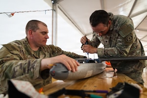 U.S. Army Staff Sgt. Nicholas Davis and Spc. Octavio Landeros, both with the Field Artillery Squadron, 2d Cavalry Regiment, secure the wings of a one-way attack Hornet drone in preparation for flight operations at Bemowo Piskie Training Area, Poland, May 3, 2026. From April 27 to May 31, 2026, U.S. and Allied forces will exercise NATO’s Eastern Flank Deterrence Initiative, demonstrating NATO’s ability to fight and win on the modern battlefield. Nearly 15,000 troops from eleven nations will train across the High North, Baltic region, and Poland, executing rapid maneuvers, air defense, counter-drone operations, and cyber defense to validate NATO’s regional defense plans in real time. This series of linked exercises, including Saber Strike, Immediate Response, and Swift Response, turns investment into capability. Soldiers integrate unmanned systems, AI-enabled command and control, and live data networks to move faster, decide faster, and fight more effectively across all domains. Sword 26 demonstrates how U.S. Army Europe and Africa drives transformation at scale while strengthening deterrence. Together with our Allies, we are building a unified, lethal force ready to defend NATO territory and respond to any threat. (U.S. Army Reserve photo by Capt. Katherine Bustos)