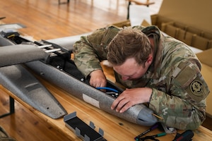 U.S. Army Staff Sgt. Terrence A. Giles, with the Field Artillery Squadron, 2d Cavalry Regiment, connects LoRa cables to establish long-range communication during the assembly of a one-way attack Hornet drone in preparation for flight operations at Bemowo Piskie Training Area, Poland, May 3, 2026. From April 27 to May 31, 2026, U.S. and Allied forces will exercise NATO’s Eastern Flank Deterrence Initiative, demonstrating NATO’s ability to fight and win on the modern battlefield. Nearly 15,000 troops from eleven nations will train across the High North, Baltic region, and Poland, executing rapid maneuvers, air defense, counter-drone operations, and cyber defense to validate NATO’s regional defense plans in real time. This series of linked exercises, including Saber Strike, Immediate Response, and Swift Response, turns investment into capability. Soldiers integrate unmanned systems, AI-enabled command and control, and live data networks to move faster, decide faster, and fight more effectively across all domains. Sword 26 demonstrates how U.S. Army Europe and Africa drives transformation at scale while strengthening deterrence. Together with our Allies, we are building a unified, lethal force ready to defend NATO territory and respond to any threat. (U.S. Army Reserve photo by Capt. Katherine Bustos)
