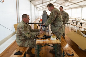 U.S. Army Staff Sgt. Nicholas Davis and Staff Sgt. Terrence Giles, with the Field Artillery Squadron, 2d Cavalry Regiment, assemble a one-way attack Hornet drone during training in preparation for flight operations at Bemowo Piskie Training Area, Poland, May 3, 2026. From April 27 to May 31, 2026, U.S. and Allied forces will exercise NATO’s Eastern Flank Deterrence Initiative, demonstrating NATO’s ability to fight and win on the modern battlefield. Nearly 15,000 troops from eleven nations will train across the High North, Baltic region, and Poland, executing rapid maneuvers, air defense, counter-drone operations, and cyber defense to validate NATO’s regional defense plans in real time. This series of linked exercises, including Saber Strike, Immediate Response, and Swift Response, turns investment into capability. Soldiers integrate unmanned systems, AI-enabled command and control, and live data networks to move faster, decide faster, and fight more effectively across all domains. Sword 26 demonstrates how U.S. Army Europe and Africa drives transformation at scale while strengthening deterrence. Together with our Allies, we are building a unified, lethal force ready to defend NATO territory and respond to any threat. (U.S. Army Reserve photo by Capt. Katherine Bustos)