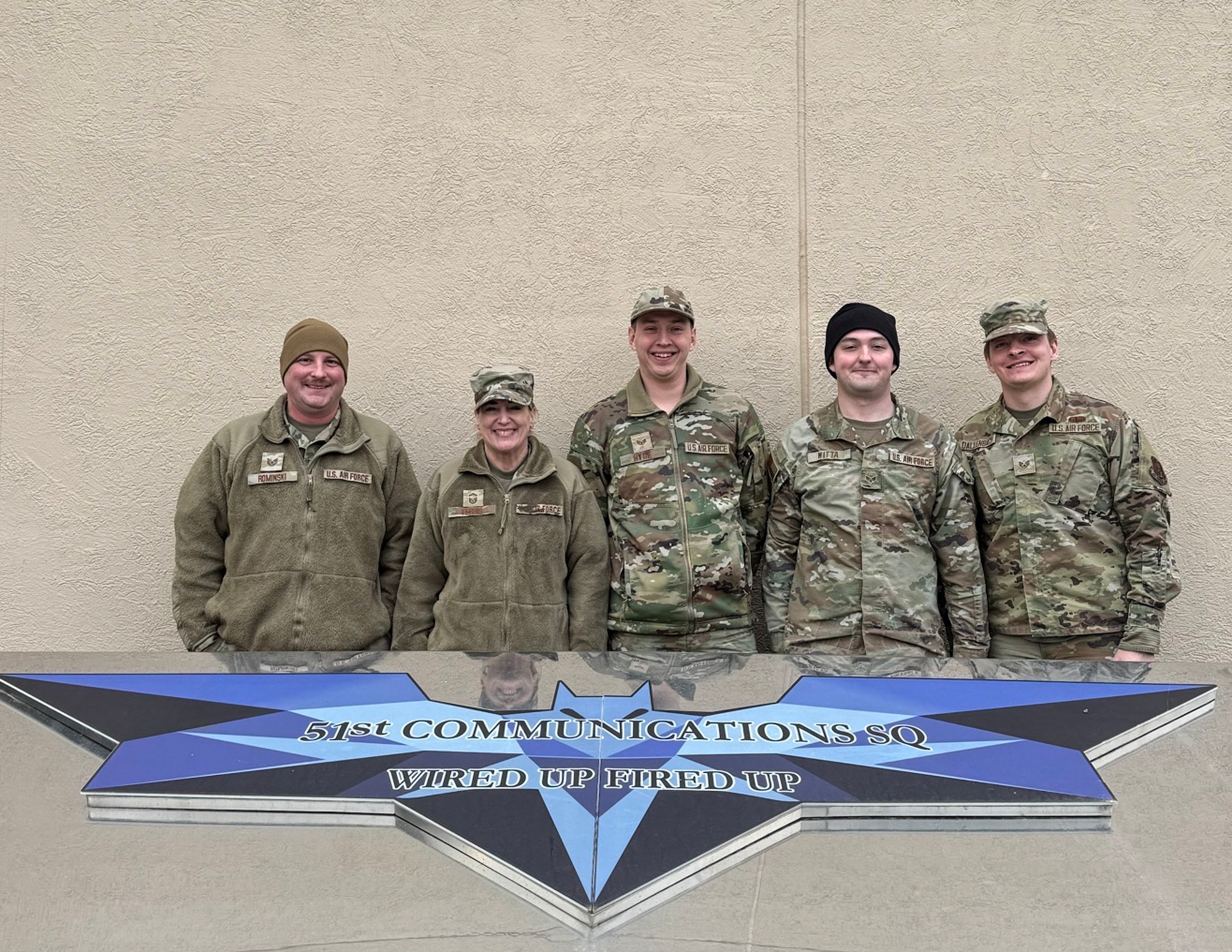 U.S. Air Force Airmen from the 133rd Communications Squadron pose for a group photo at Osan Air Base, South Korea, March 11, 2026.