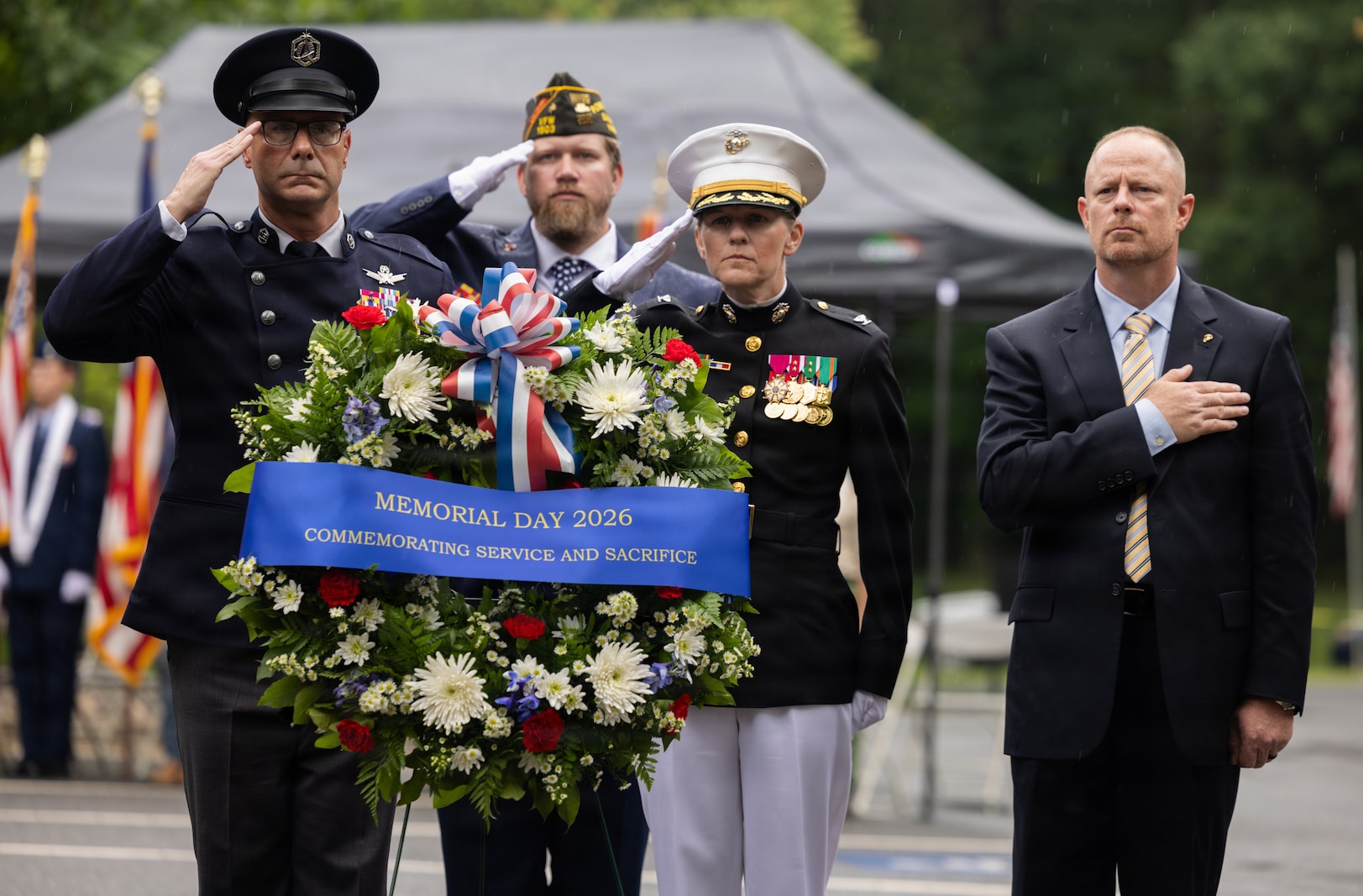 U.S. Space Force Chief Master Sgt. John Bentivegna, chief master sergeant of the Space Force, left, Charles Marlow Jr., sergeant at arms for Veterans of Foreign Wars Post 1503, U.S. Marine Corps Col. Jenny Colegate, the commanding officer of Marine Corps Base Quantico, and Damion Jacobs, director of the National Memorial Cemetery at Quantico, salute for the playing of Taps during the Memorial Day Wreath Laying Ceremony at the NMCAQ, Triangle, Virginia, May 25, 2026. The ceremony is held annually on Memorial Day weekend to honor the memory and military service of those who lost their lives while serving. (U.S. Marine Corps photo by Sgt. Chancellor Reynolds)