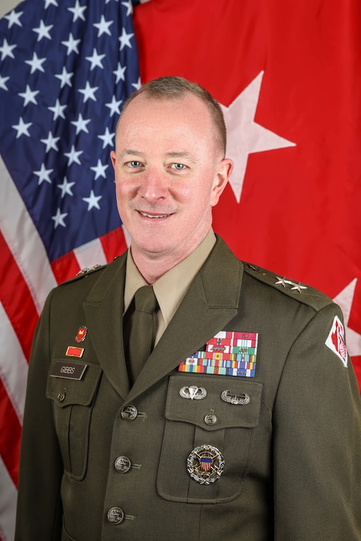 Biography Photo of a Man in front of two flags