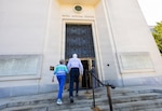 Former U.S. Navy pilot Mike Flannery and his wife, Carol, a former U.S. Navy nurse, enter Walter Reed National Military Medical Center, May 18, 2026, in Bethesda, Maryland, for the first time in more than five decades. The couple met at the hospital in 1969 and returned this month as part of a trip to Washington, D.C. (DOW photo by Ricardo J. Reyes)